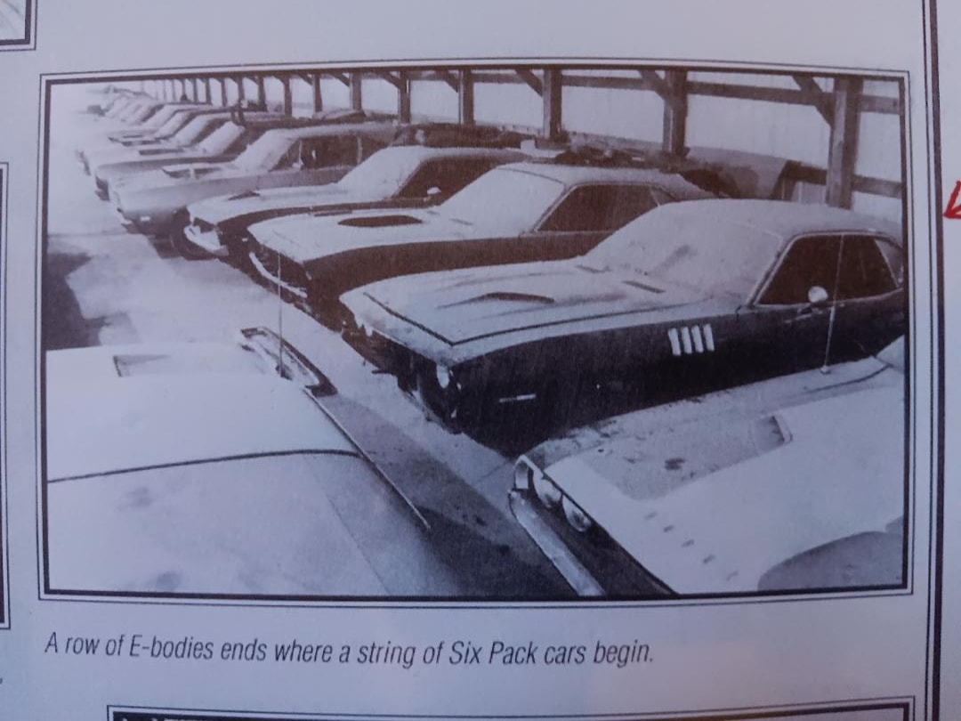 The Curator's TX9 HemiCuda sitting in the exclusive covered barn at R&R Salvage — roll cage visible, among the finest Hemis and 440-6 Pack Mopars in Ron Slobe's private collection