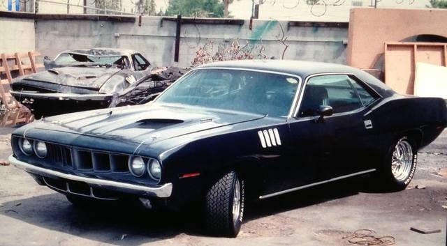 Phantasm II stunt Cudas — black Cuda front three-quarter, wrecked second Cuda behind