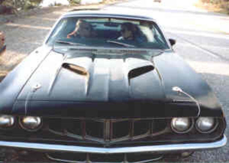 Two figures reflected in the windshield — Phantasm III Cuda, front-on hood shot