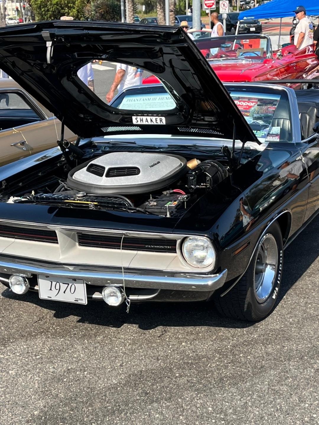 The black 1970 Phantasm HemiCuda convertible displayed with its hood open at a car show